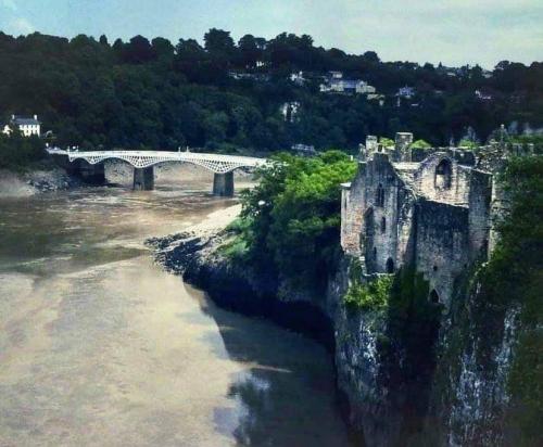old wye bridge and castle under dark clouds